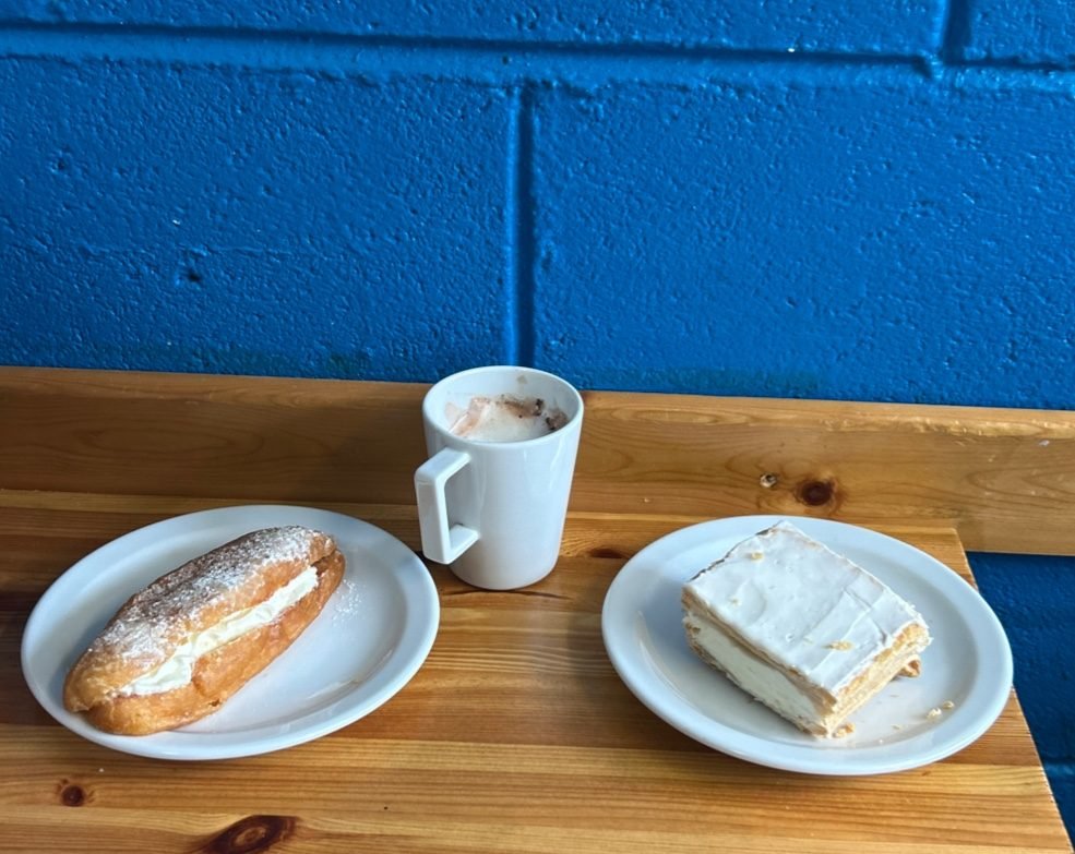 Cream-filled doughnut and a vanilla slice with coffee